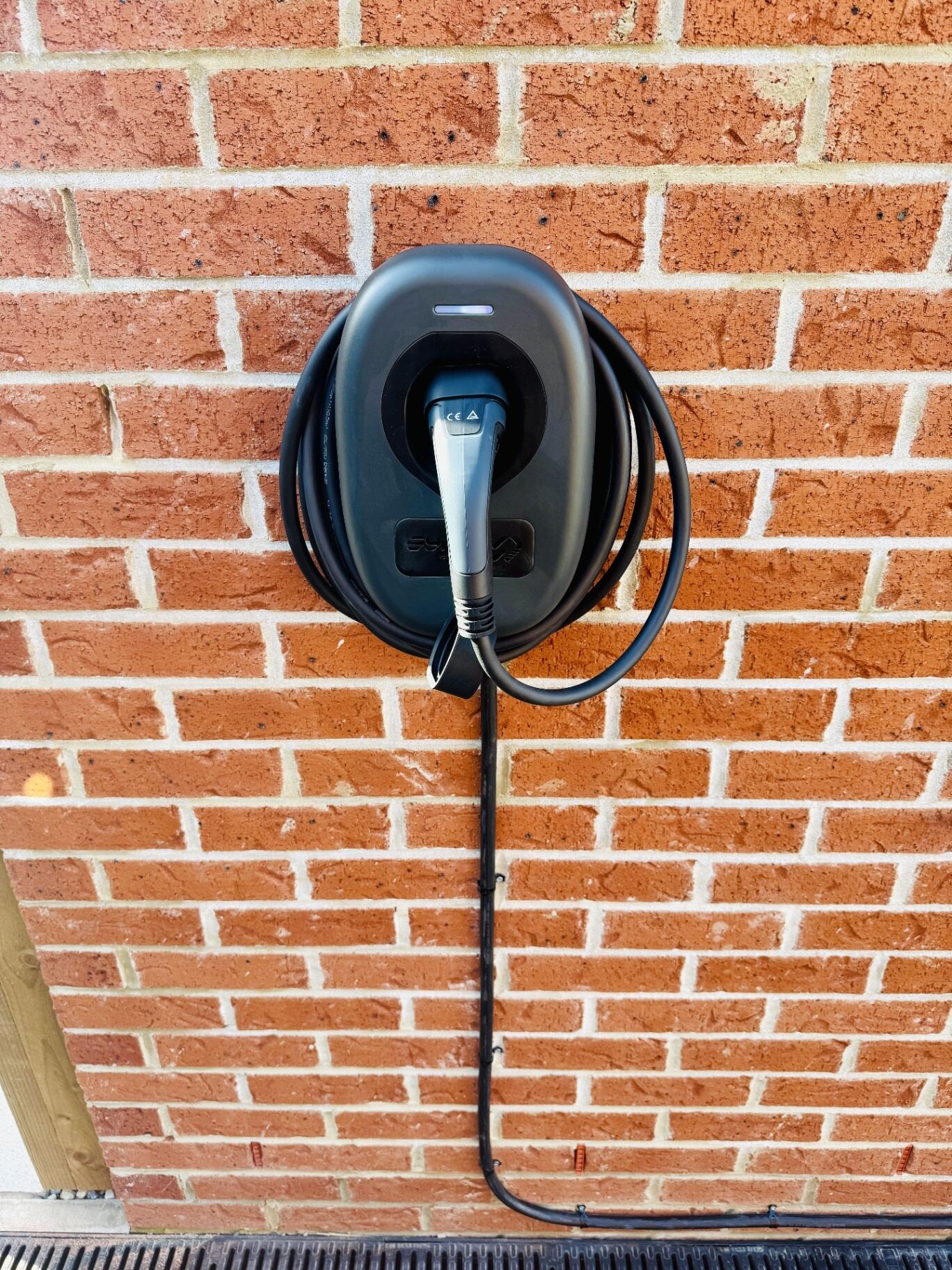Untethered EV charge point installed on a red brick wall