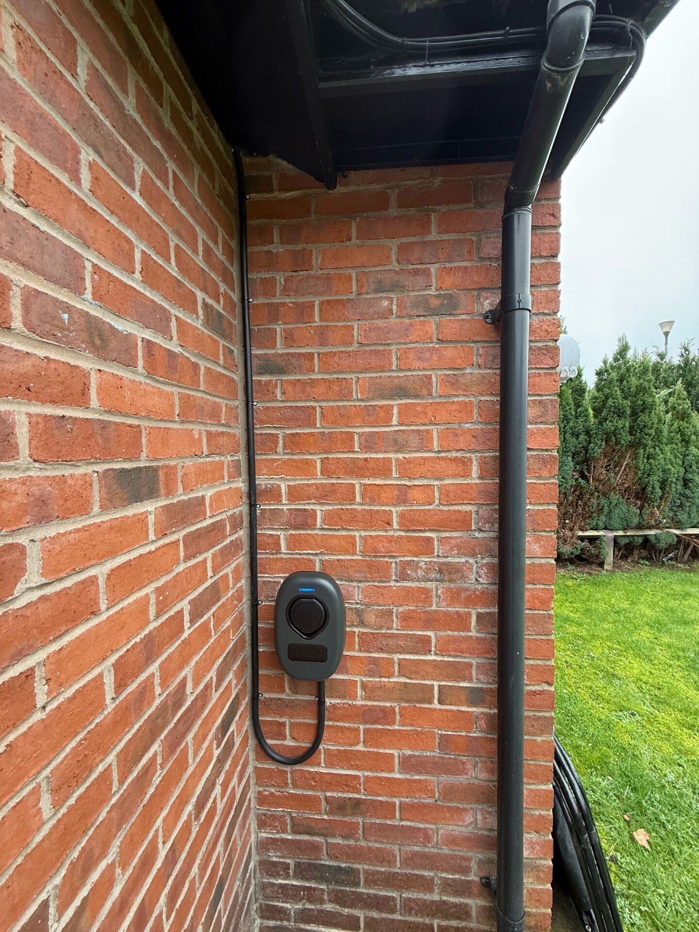 Domestic EV charger installed on brickwork